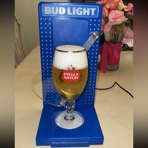 Neon light display beer holder with fake beer with foam in a Stella glass